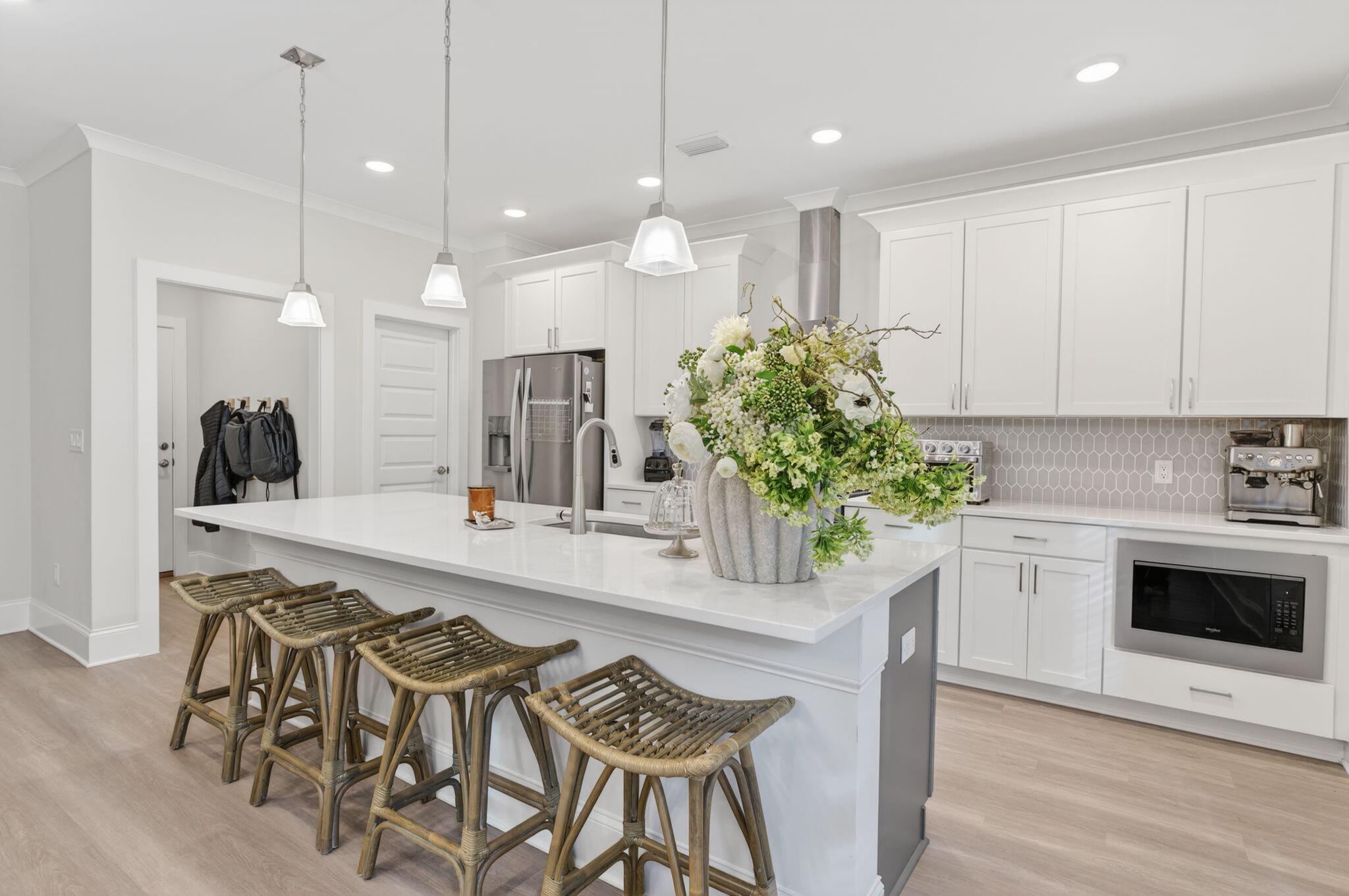 66 North J Hunters Way Freeport, FL 32439 - Photo 11 of 30 a kitchen with white cabinets stainless steel appliances and kitchen view