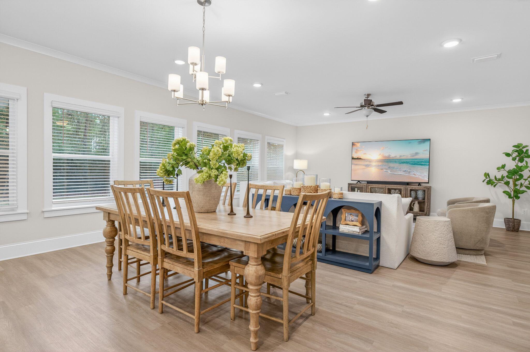 66 North J Hunters Way Freeport, FL 32439 - Photo 8 of 30 a view of a dining room with furniture window and wooden floor