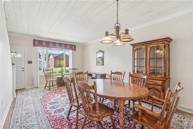 a dining room with furniture a chandelier and window