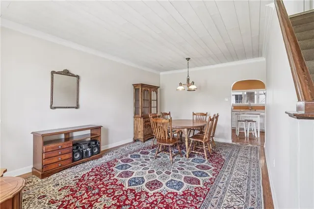 a dining room with furniture and wooden floor