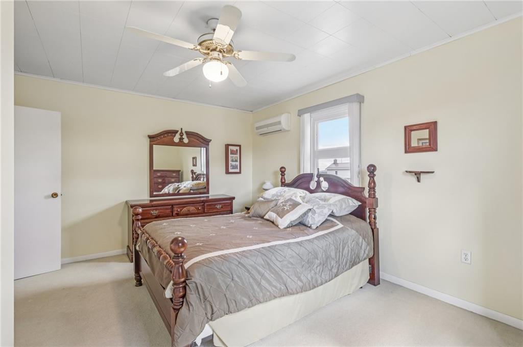 807 Kaye Avenue Monaca, PA 15061 - Photo 30 of 41 a bedroom with a bed and a chandelier