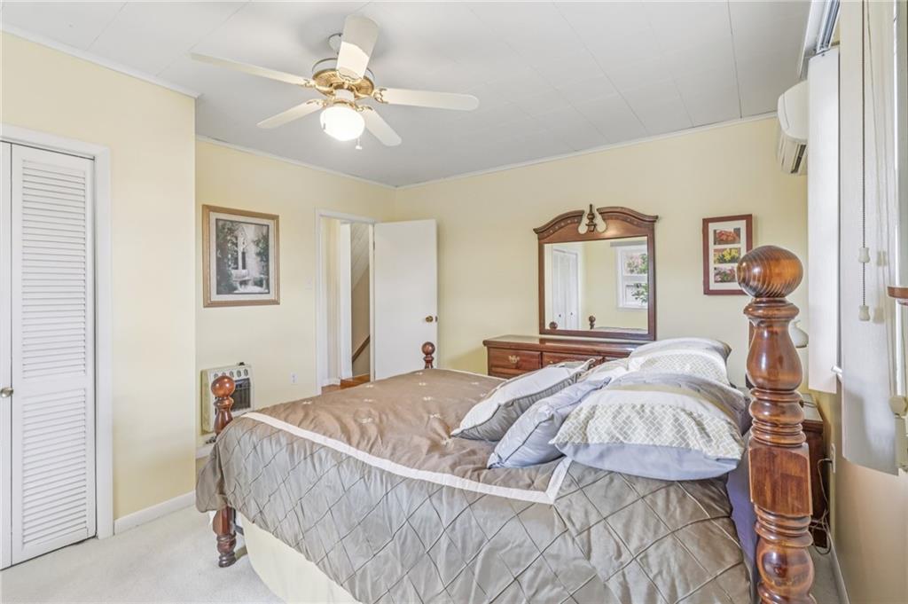 807 Kaye Avenue Monaca, PA 15061 - Photo 31 of 41 a bedroom with a bed and a chandelier