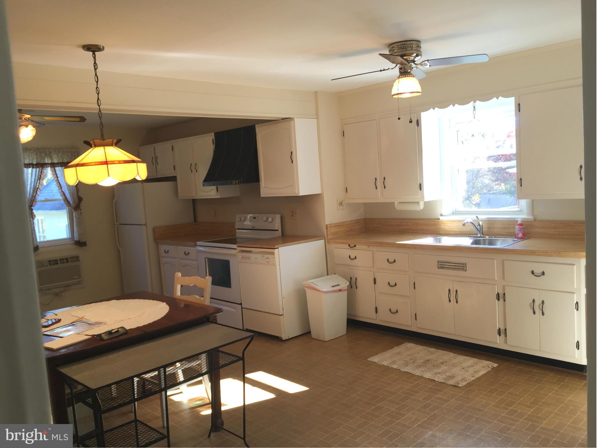 3025 Ridge Road Baltimore, MD 21244 - Photo 8 of 27 a kitchen with white cabinets and sink