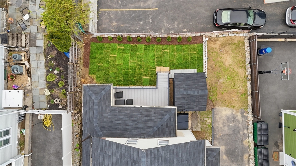 9 Robbins Street Waltham, MA 02453 - Photo 39 of 42 a aerial view of a house with a garden and outdoor seating