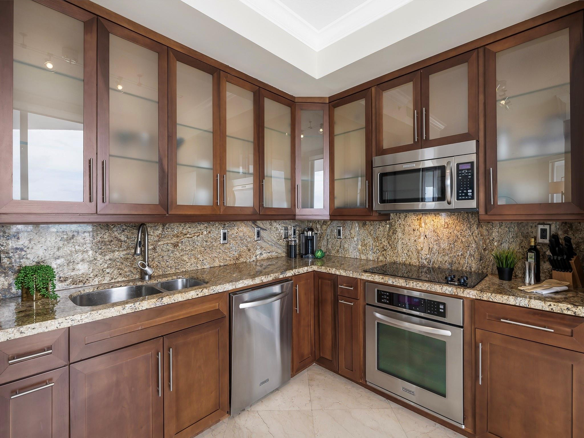 100 South Birch Road, Unit 2504 Fort Lauderdale, FL 33316 - Photo 11 of 42 a kitchen with stainless steel appliances granite countertop a sink and stove top oven