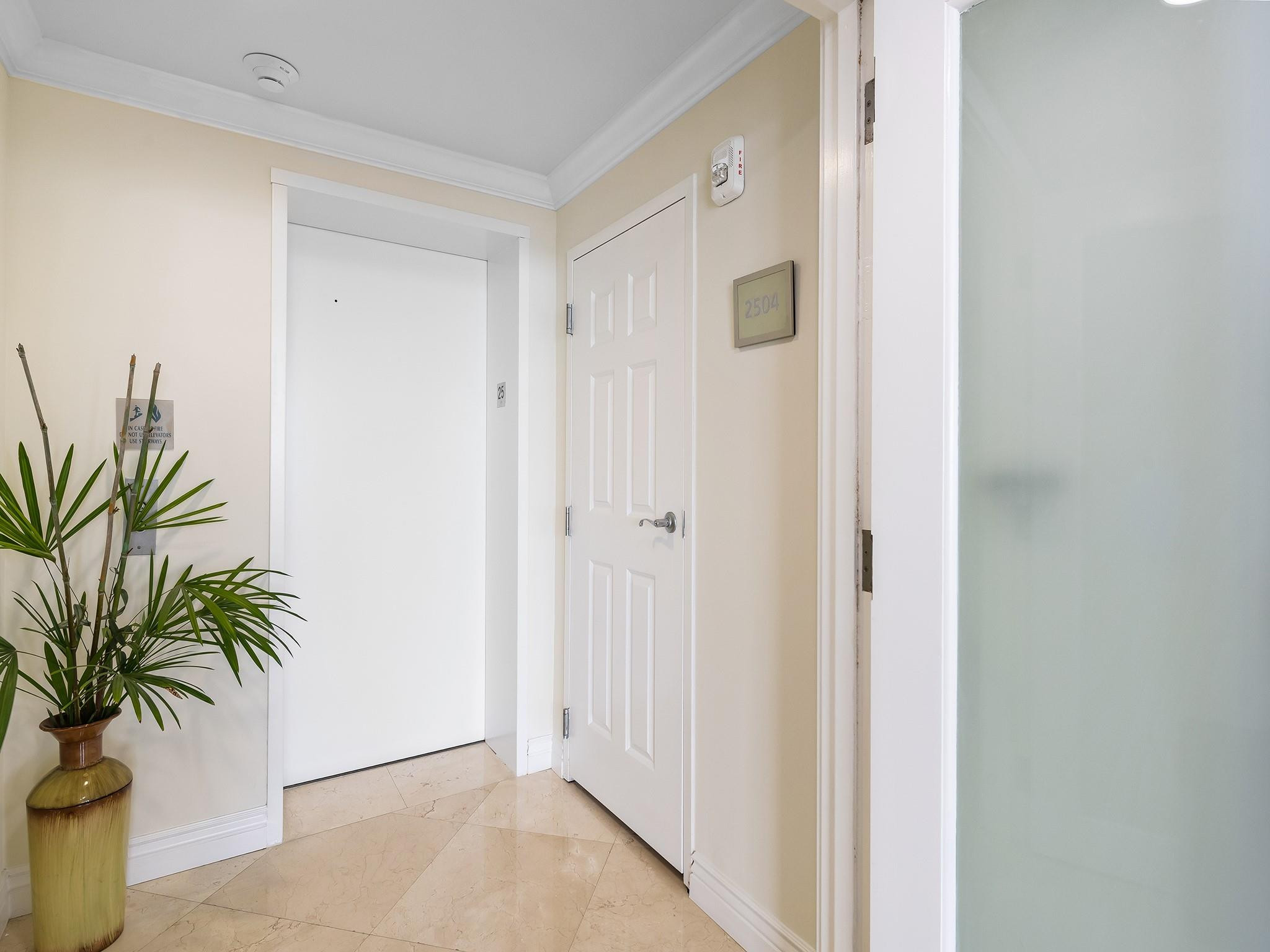 100 South Birch Road, Unit 2504 Fort Lauderdale, FL 33316 - Photo 27 of 42 a view of a hallway with potted plants
