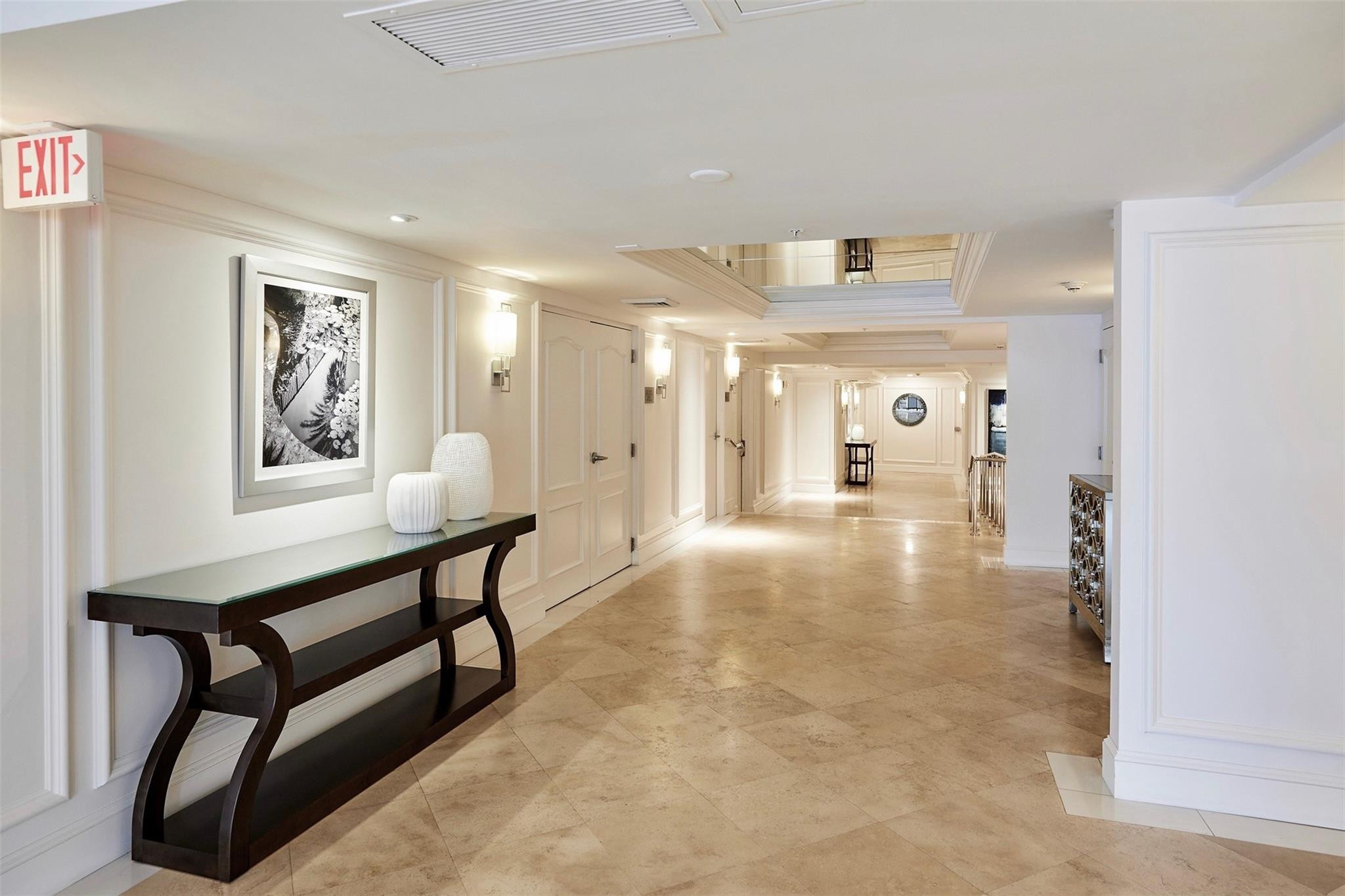 100 South Birch Road, Unit 2504 Fort Lauderdale, FL 33316 - Photo 28 of 42 a view of a hallway to a livingroom with furniture and a window