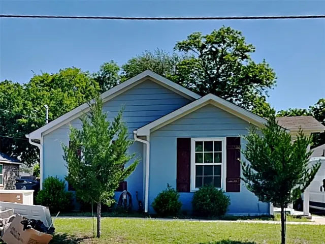 a house that has a tree in front of it