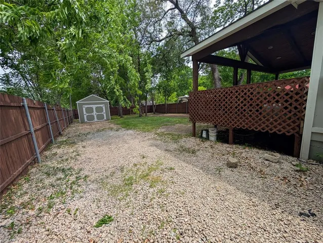 a view of a chair and table in backyard