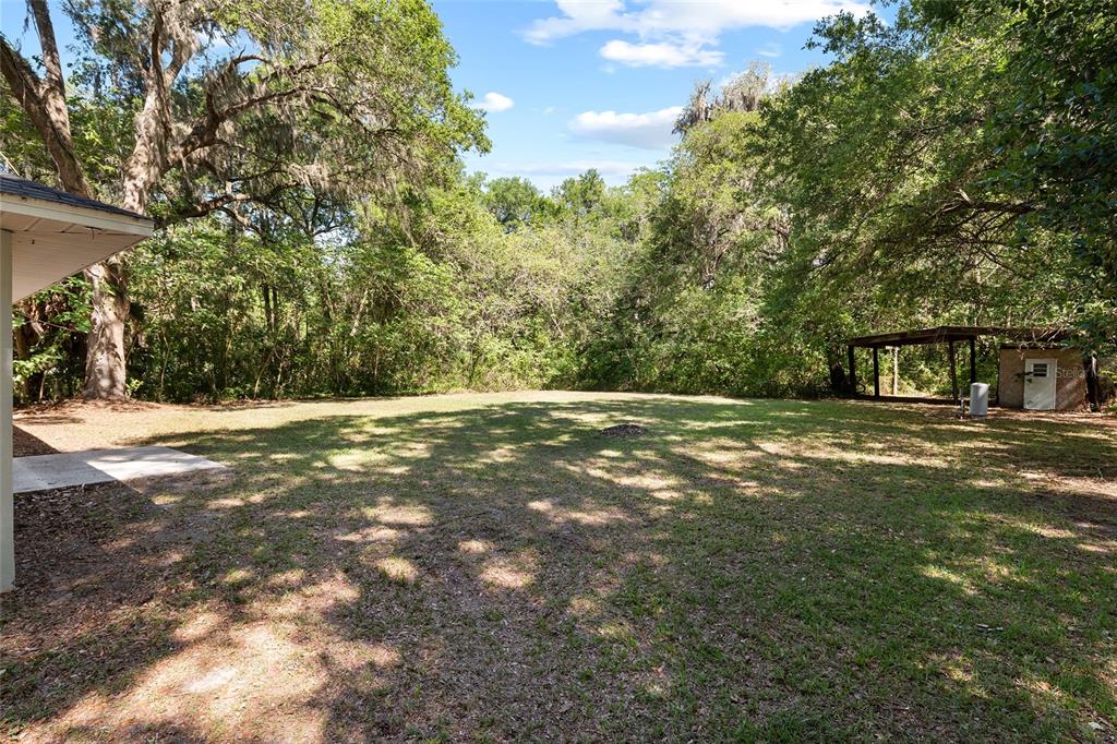 4329 Northwest 155th Street Reddick, FL 32686 - Photo 46 of 52 a view of outdoor space with deck and yard