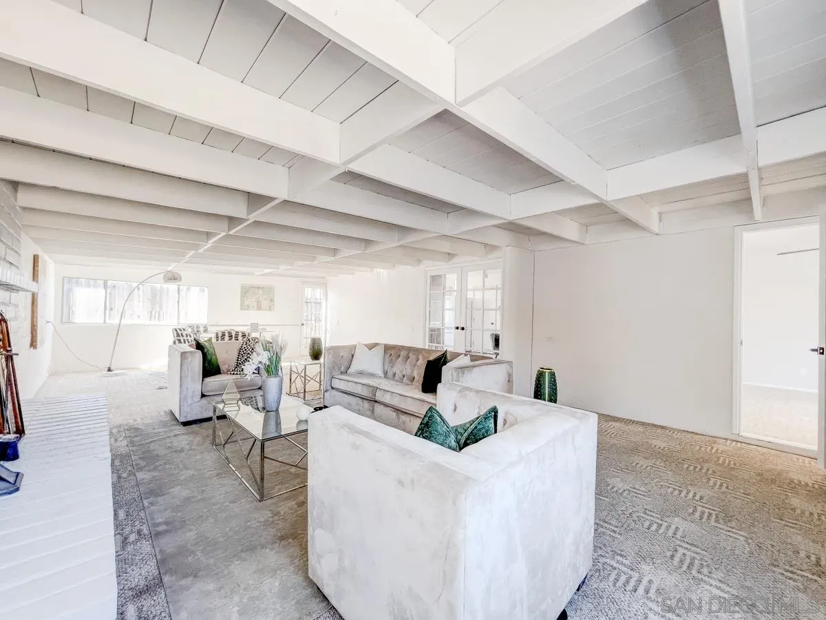 2922 Luana Drive Oceanside, CA 92056 - Photo 12 of 28 a living room with couches and kitchen view with wooden floor