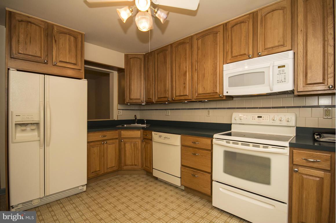 27 Rhodes Place Lutherville-Timonium, MD 21093 - Photo 2 of 19 a kitchen with stainless steel appliances granite countertop a refrigerator a stove and a sink