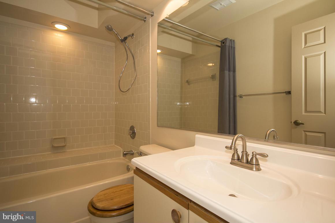 27 Rhodes Place Lutherville-Timonium, MD 21093 - Photo 11 of 19 a bathroom with a granite countertop sink a toilet and shower
