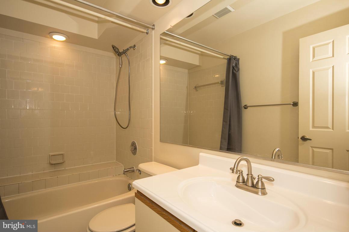 27 Rhodes Place Lutherville-Timonium, MD 21093 - Photo 14 of 19 a bathroom with a granite countertop sink toilet and shower