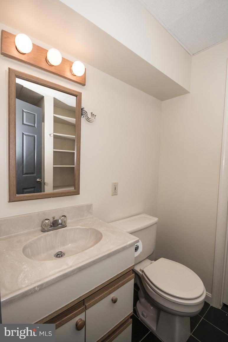 27 Rhodes Place Lutherville-Timonium, MD 21093 - Photo 16 of 19 a bathroom with a sink toilet and mirror