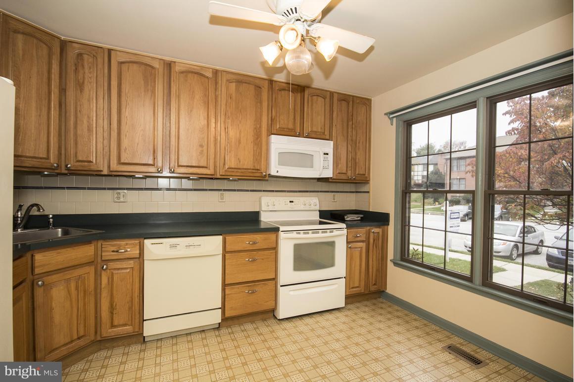 27 Rhodes Place Lutherville-Timonium, MD 21093 - Photo 3 of 19 a kitchen with stainless steel appliances granite countertop a stove a sink and white cabinets