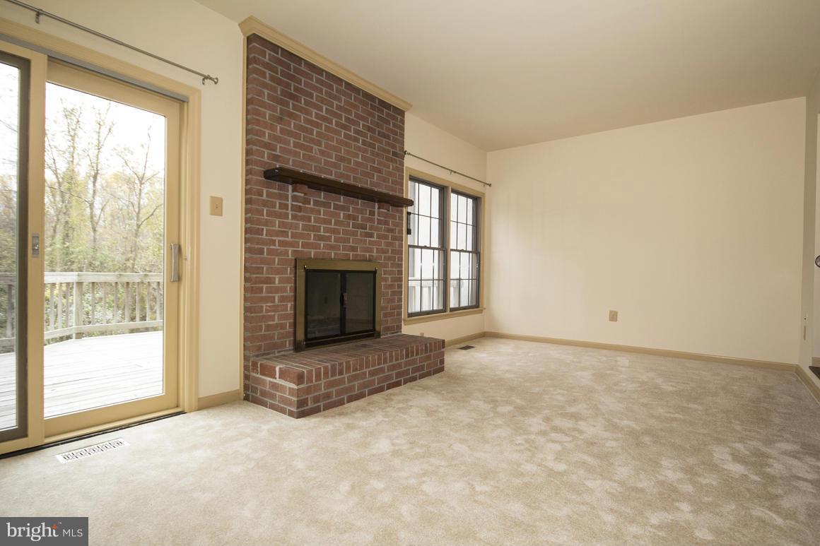 27 Rhodes Place Lutherville-Timonium, MD 21093 - Photo 6 of 19 a view of an empty room with a fireplace and a window