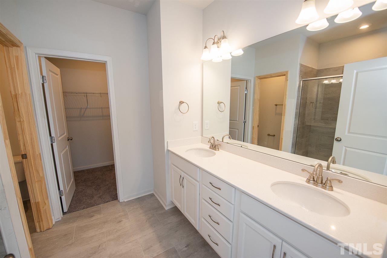 3620 Buffaloe Road, Unit 1 Raleigh, NC 27604 - Photo 13 of 25 a bathroom with double vanity sinks and a mirror