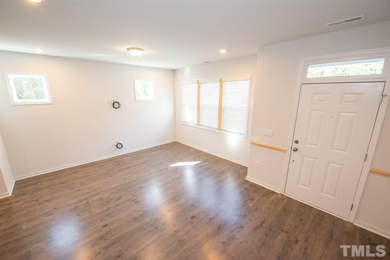 3620 Buffaloe Road, Unit 1 Raleigh, NC 27604 - Photo 3 of 25 an empty room with wooden floor and windows