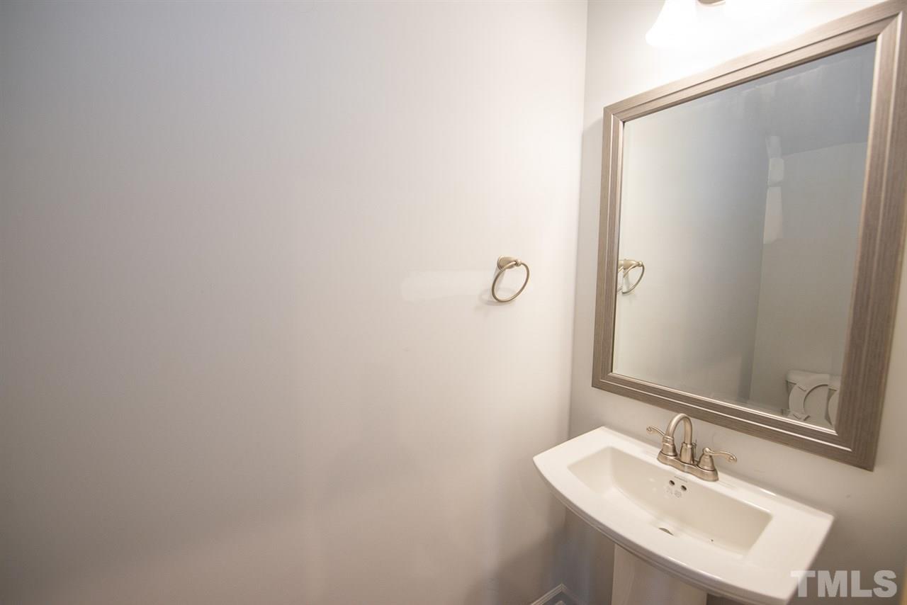 3620 Buffaloe Road, Unit 1 Raleigh, NC 27604 - Photo 9 of 25 a bathroom with a sink and a mirror