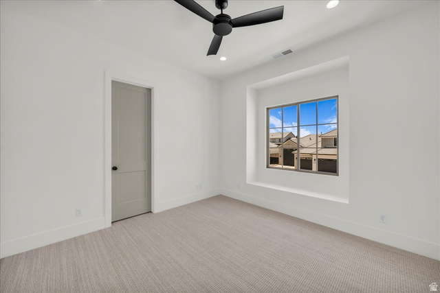 1620 Belayer Drive St. George, UT 84770 - Photo 31 of 51 Crisp white walls define this room featuring textured carpeting, a recessed window with a deep sill, and a modern black ceiling fan with integrated lighting