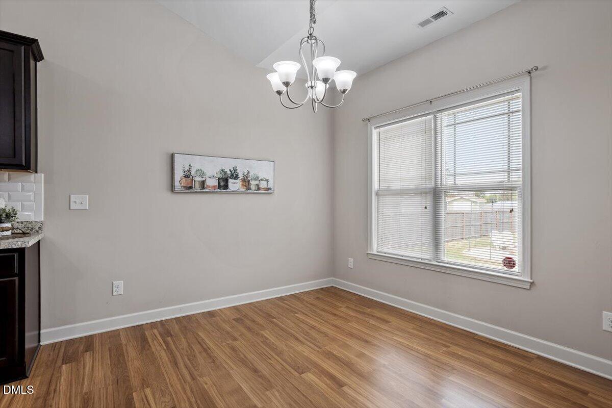 35 Fox Run Court Benson, NC 27504 - Photo 14 of 54 a view of empty room with wooden floor and fan