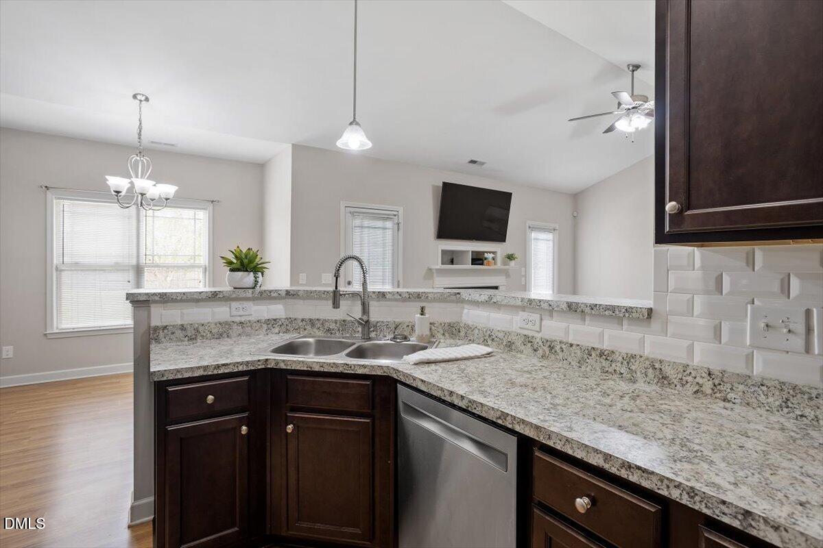 35 Fox Run Court Benson, NC 27504 - Photo 16 of 54 a kitchen with a granite countertop sink and a wooden floor