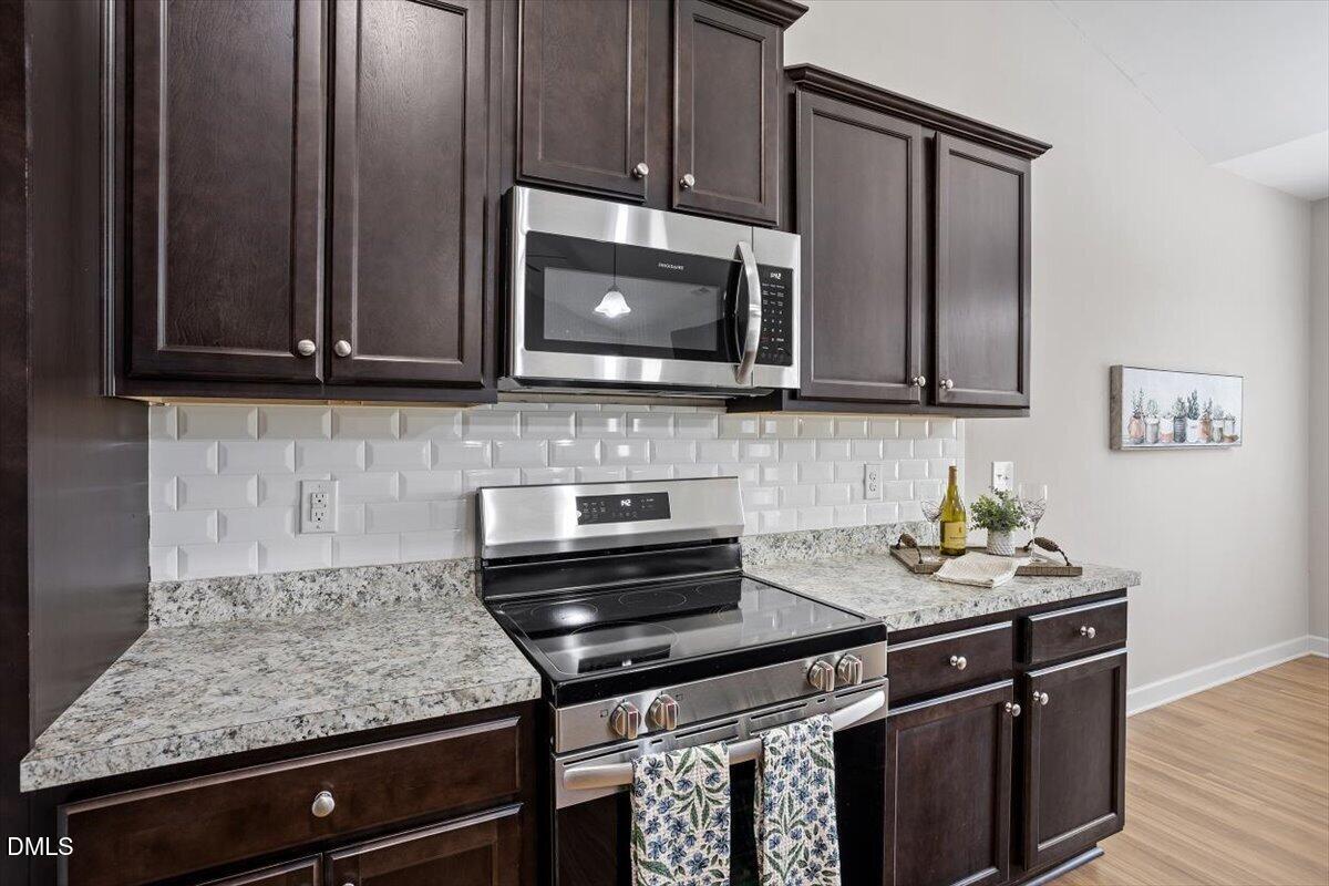 35 Fox Run Court Benson, NC 27504 - Photo 17 of 54 a kitchen with stainless steel appliances granite countertop a stove microwave and cabinets