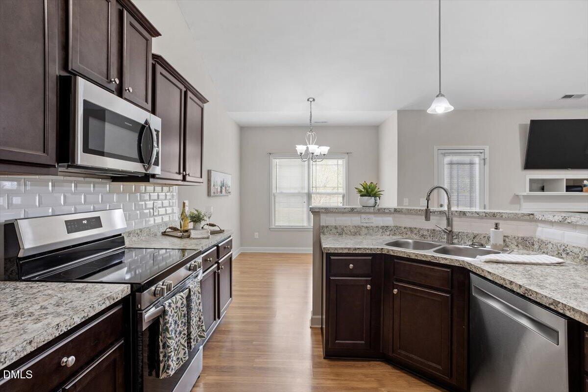 35 Fox Run Court Benson, NC 27504 - Photo 18 of 54 a kitchen with stainless steel appliances granite countertop a sink stove and microwave
