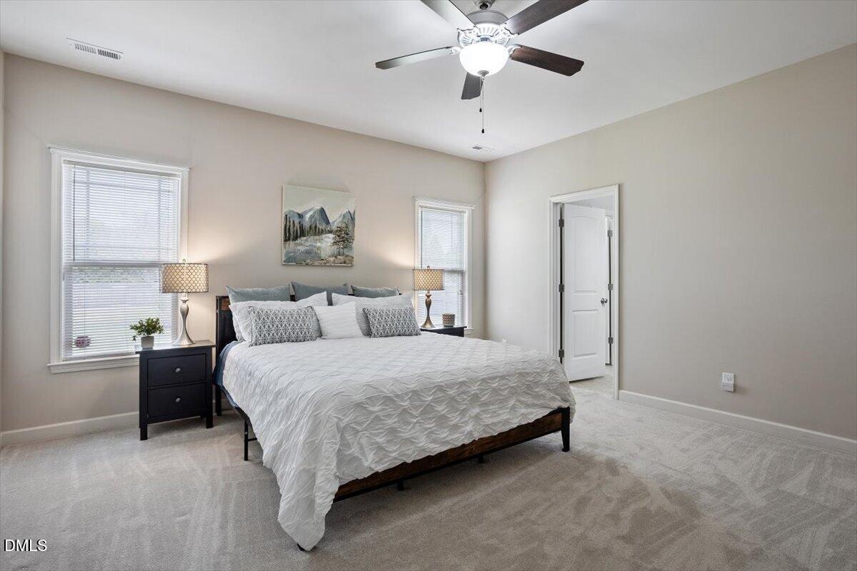35 Fox Run Court Benson, NC 27504 - Photo 20 of 54 a spacious bedroom with a bed and a chandelier