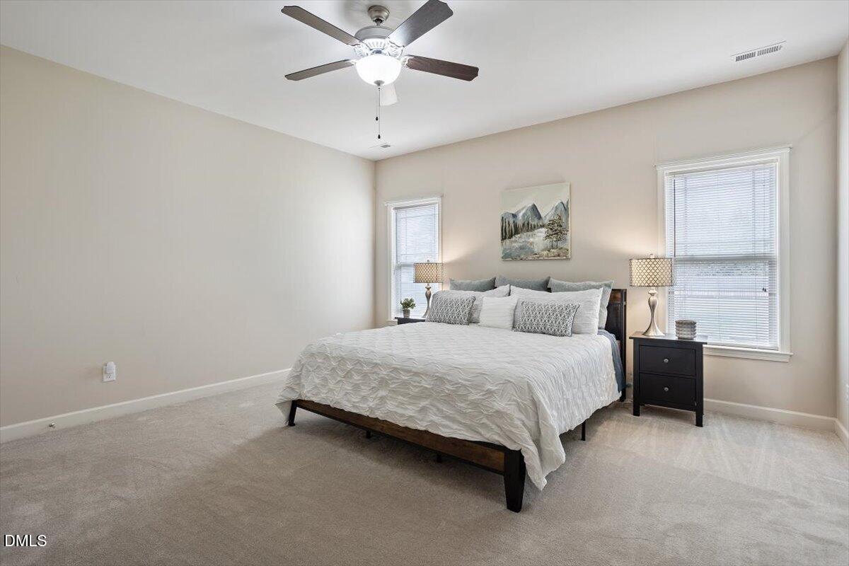 35 Fox Run Court Benson, NC 27504 - Photo 21 of 54 a spacious bedroom with a bed and a chandelier