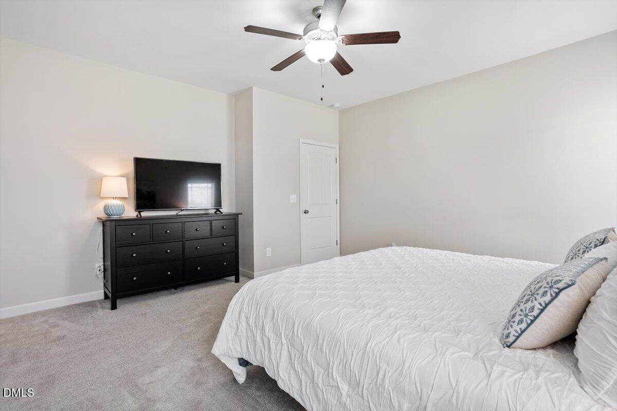 35 Fox Run Court Benson, NC 27504 - Photo 22 of 54 a bedroom with a bed and a flat tv screen on dresser