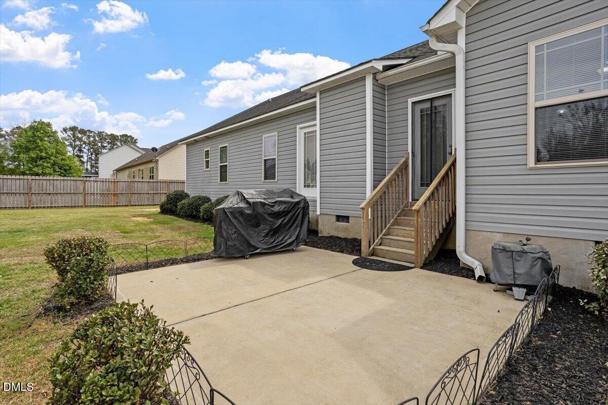 35 Fox Run Court Benson, NC 27504 - Photo 45 of 54 a backyard of a house with yard and outdoor seating
