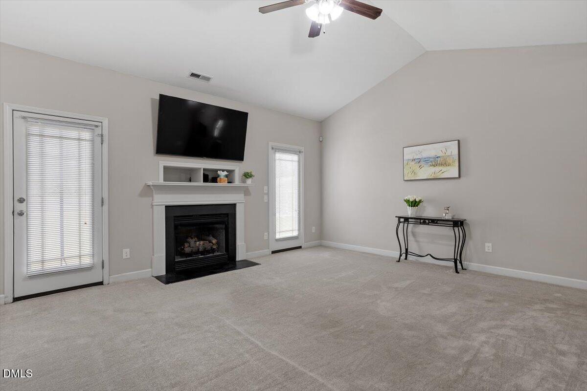 35 Fox Run Court Benson, NC 27504 - Photo 7 of 54 a living room with furniture a fireplace and a flat screen tv