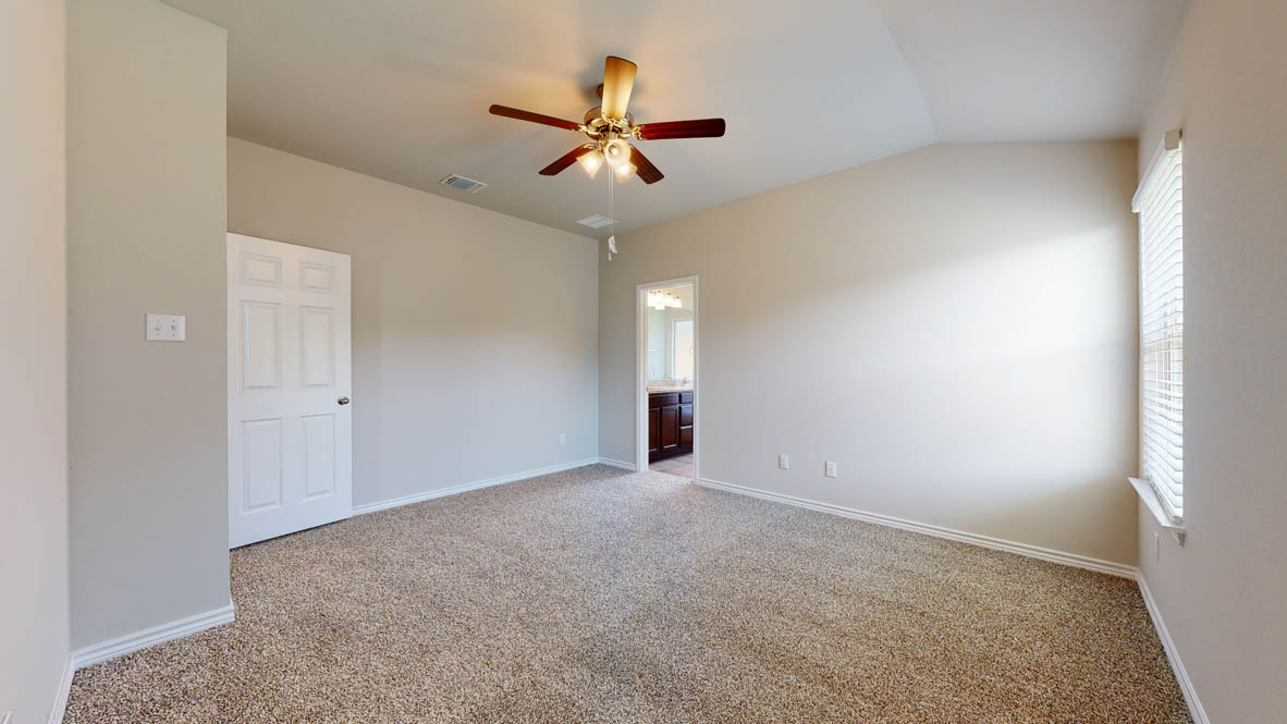 405 Creekfall Road Burnet, TX 78611 - Photo 11 of 27 an empty room with ceiling fan and window
