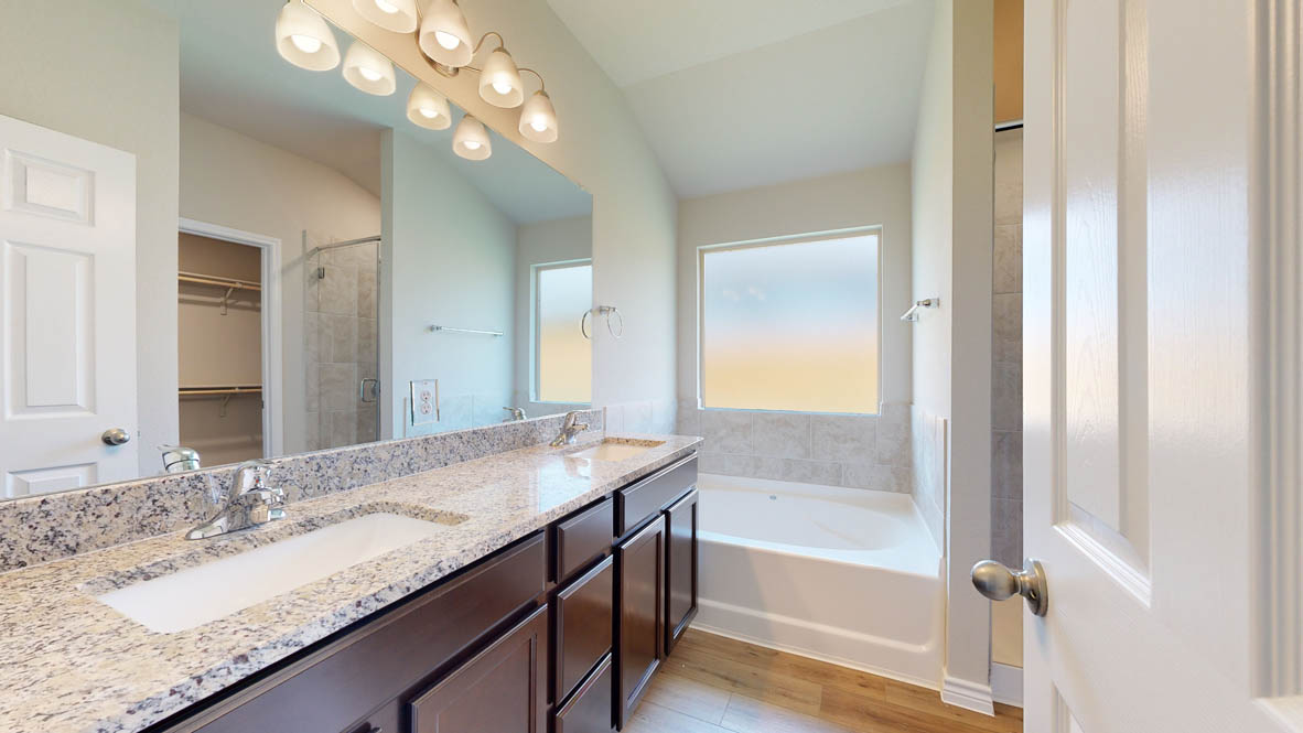 405 Creekfall Road Burnet, TX 78611 - Photo 14 of 27 a bathroom with a granite countertop sink a bathtub and a mirror