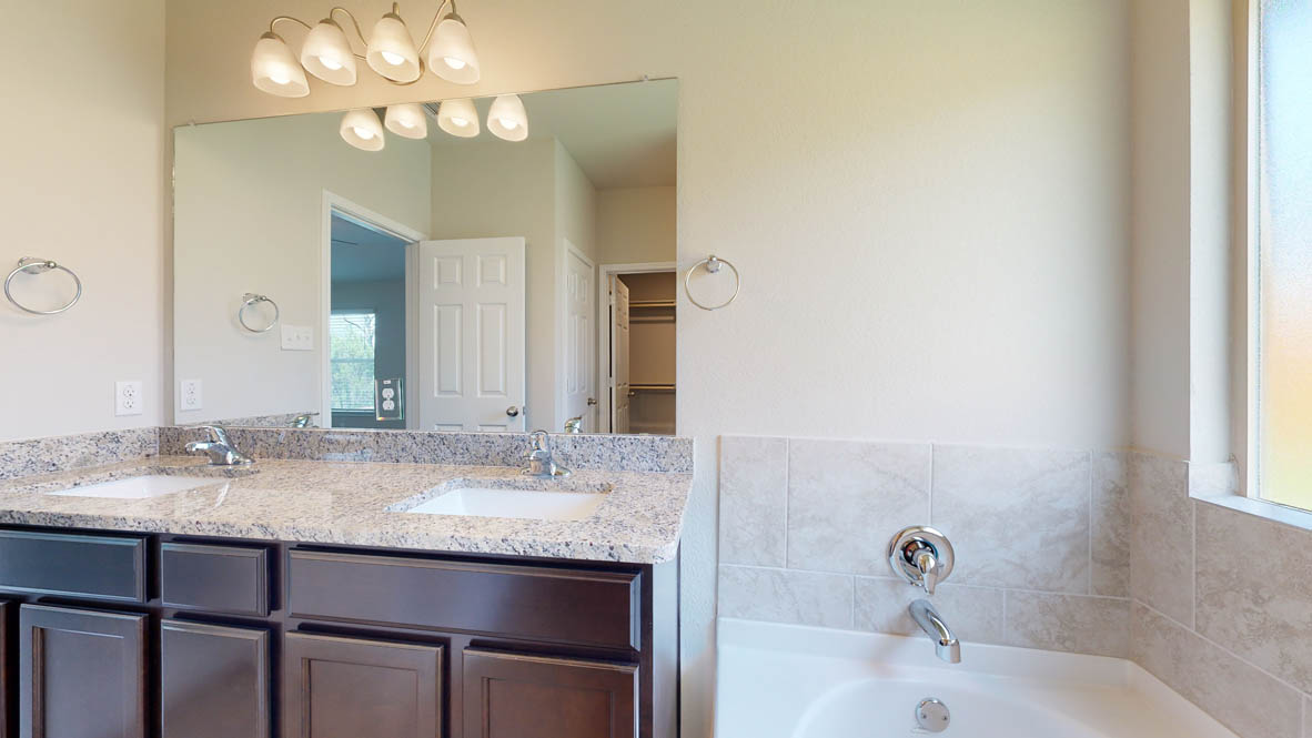 405 Creekfall Road Burnet, TX 78611 - Photo 16 of 27 a bathroom with a sink and a mirror
