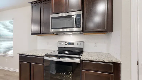 a kitchen with a stove microwave and sink