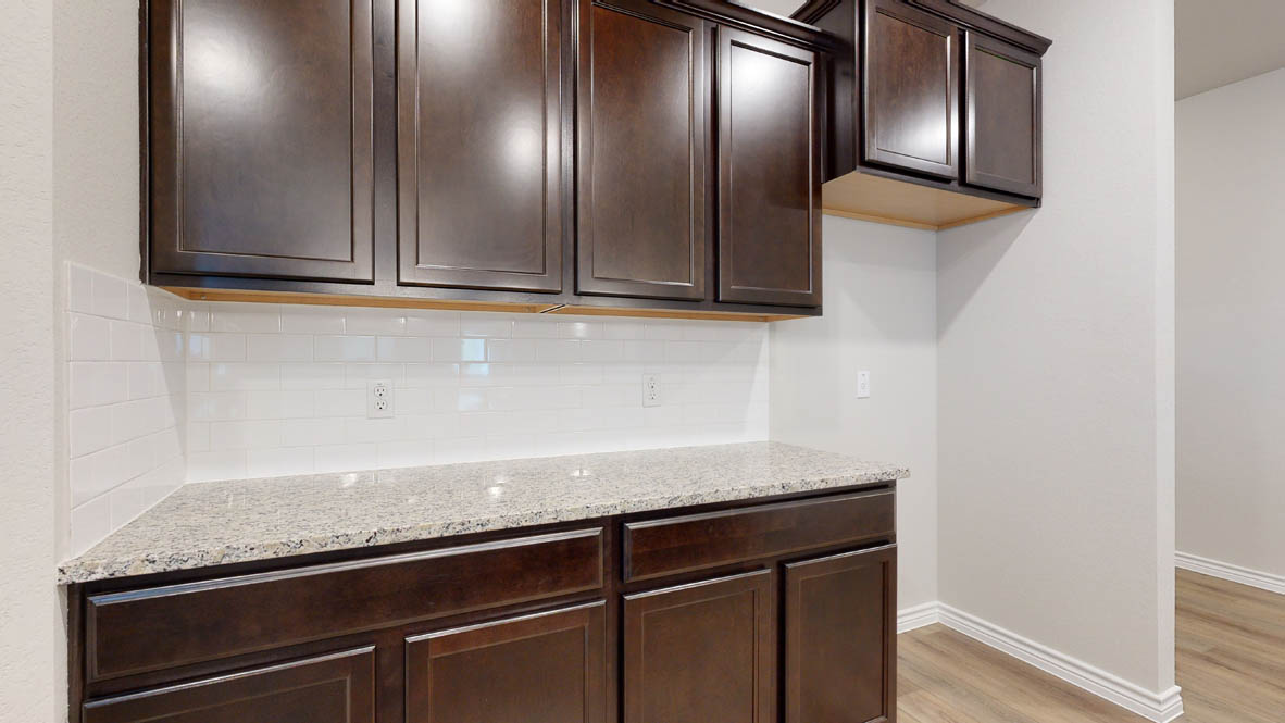 405 Creekfall Road Burnet, TX 78611 - Photo 5 of 27 a kitchen with granite countertop stainless steel appliances and cabinets
