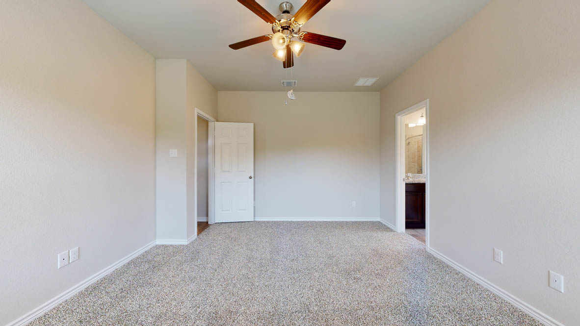 405 Creekfall Road Burnet, TX 78611 - Photo 9 of 27 an empty room with closet and a chandelier fan