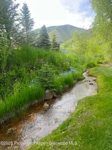 a view of a street with a yard