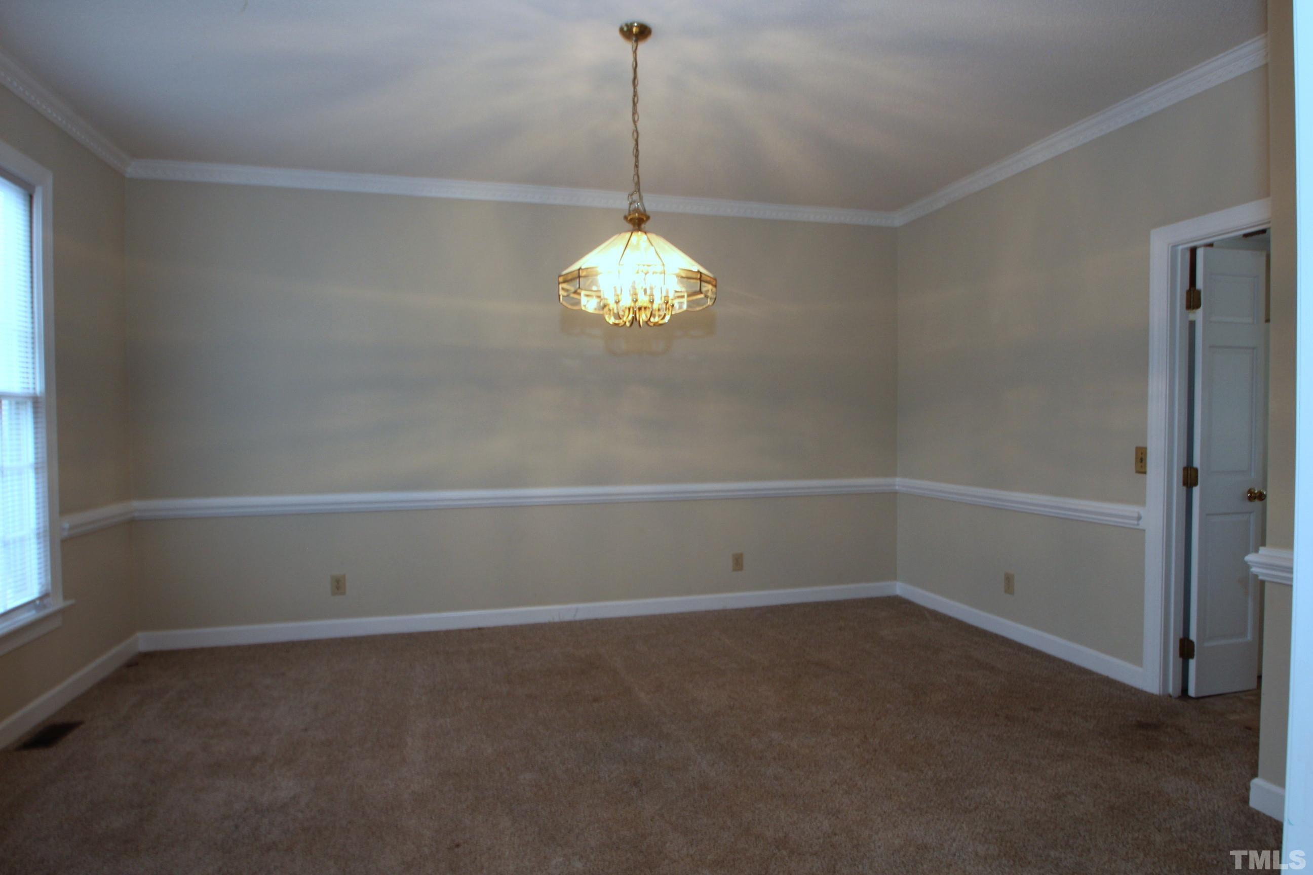 4013 Country Village Drive Raleigh, NC 27606 - Photo 12 of 23 a room with a chandelier and fan