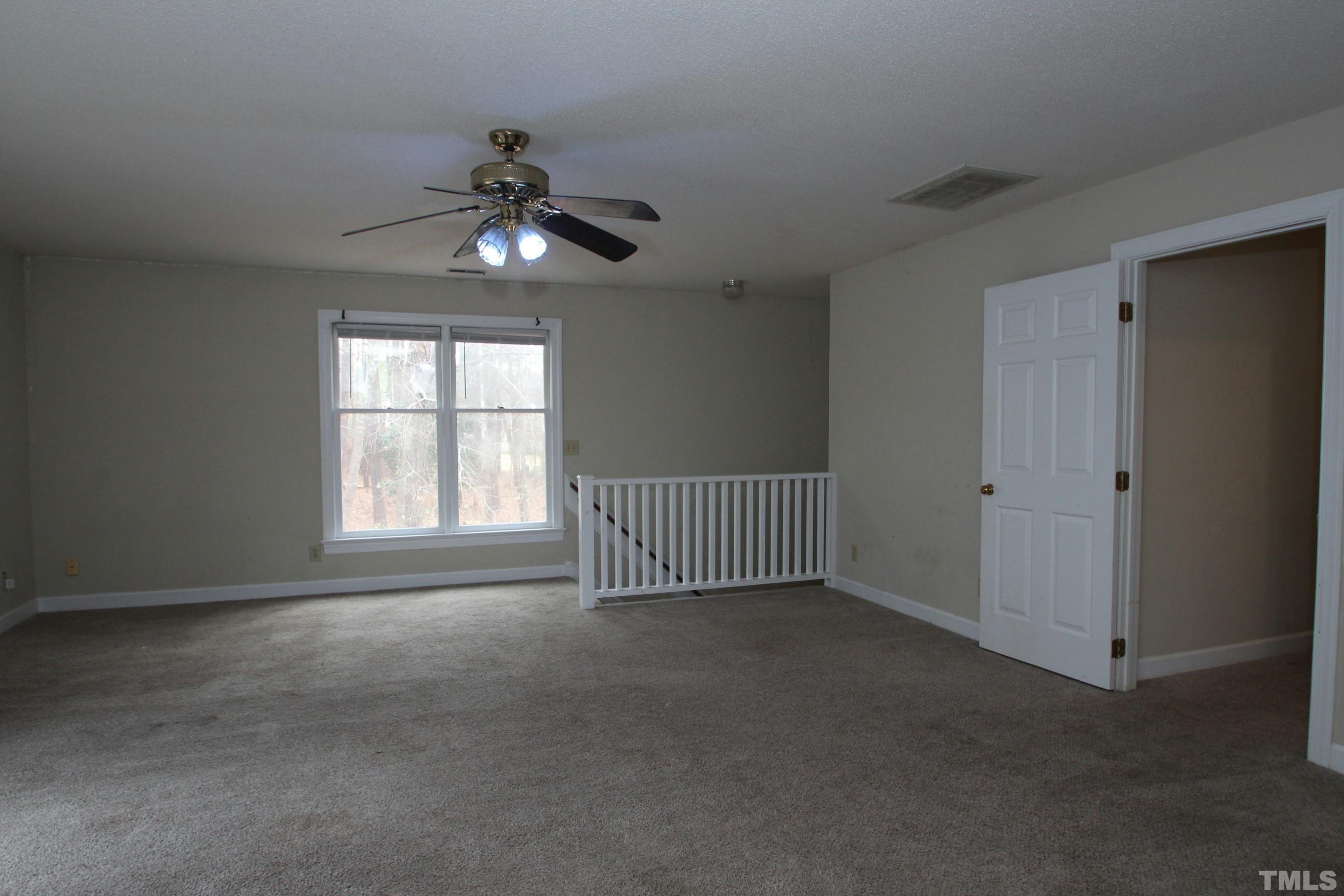 4013 Country Village Drive Raleigh, NC 27606 - Photo 14 of 23 a view of an empty room with a window