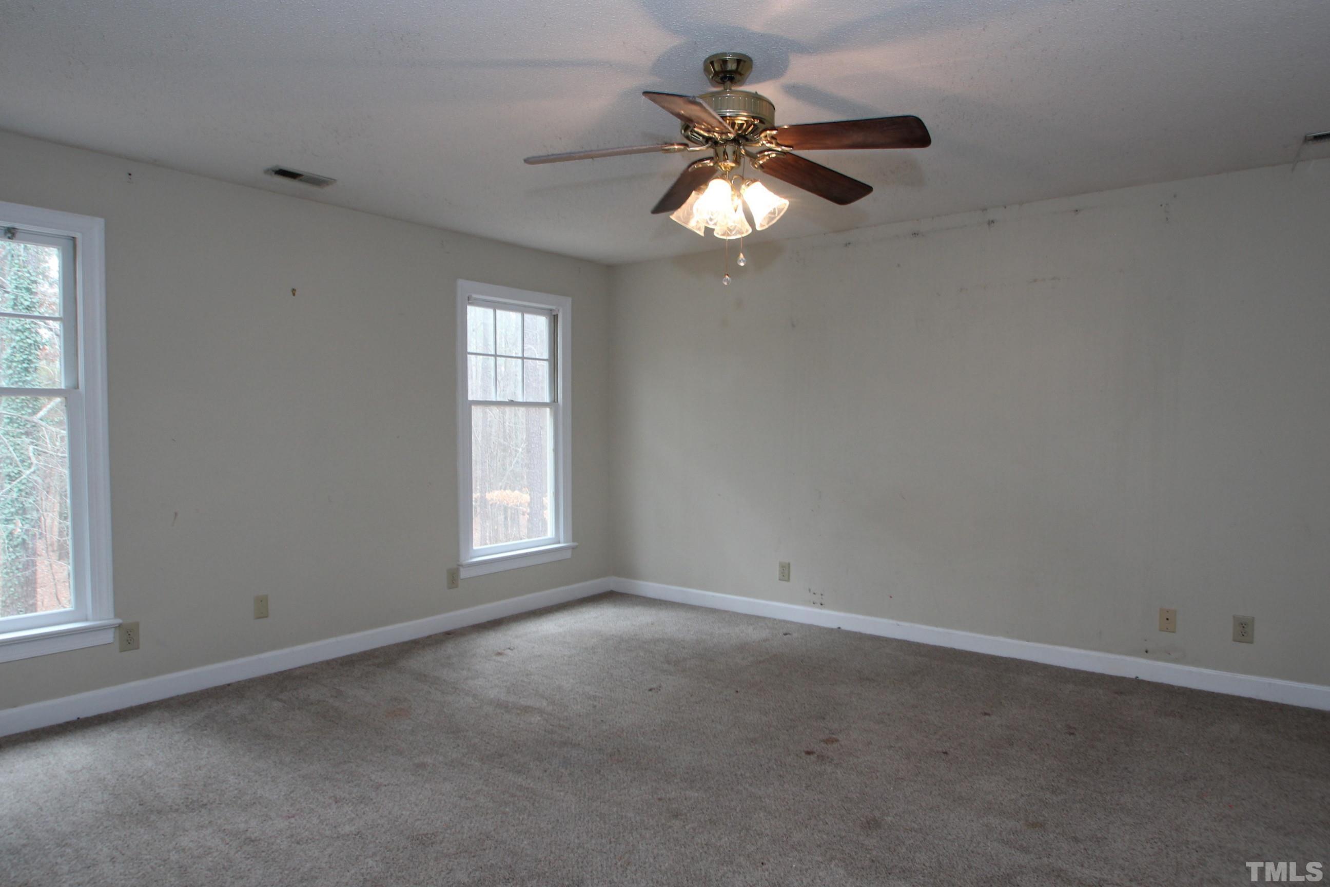 4013 Country Village Drive Raleigh, NC 27606 - Photo 18 of 23 an empty room with a window and a fan