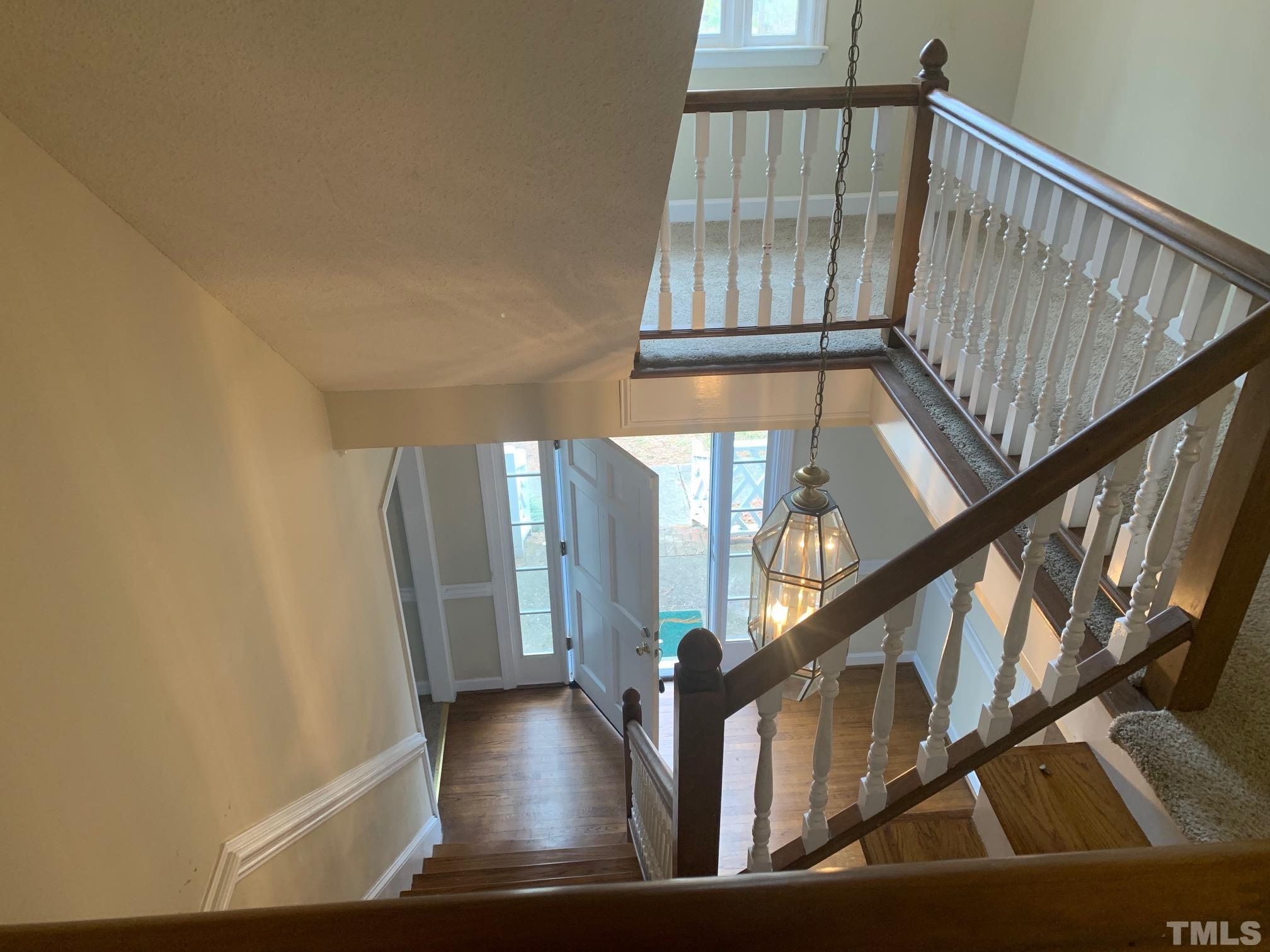 4013 Country Village Drive Raleigh, NC 27606 - Photo 2 of 23 a view of staircase with wooden floor and a front door