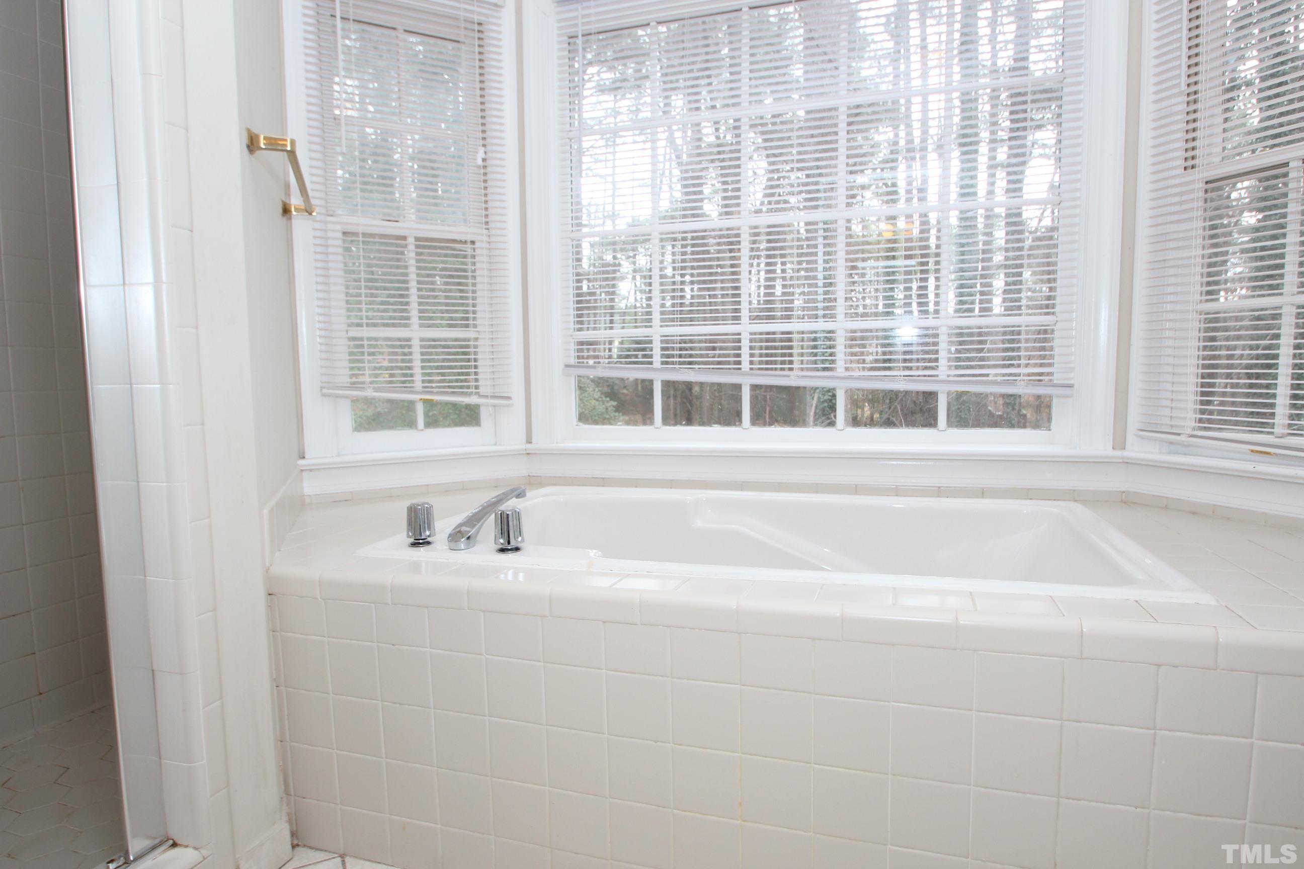 4013 Country Village Drive Raleigh, NC 27606 - Photo 21 of 23 a bath tub sitting next to a window