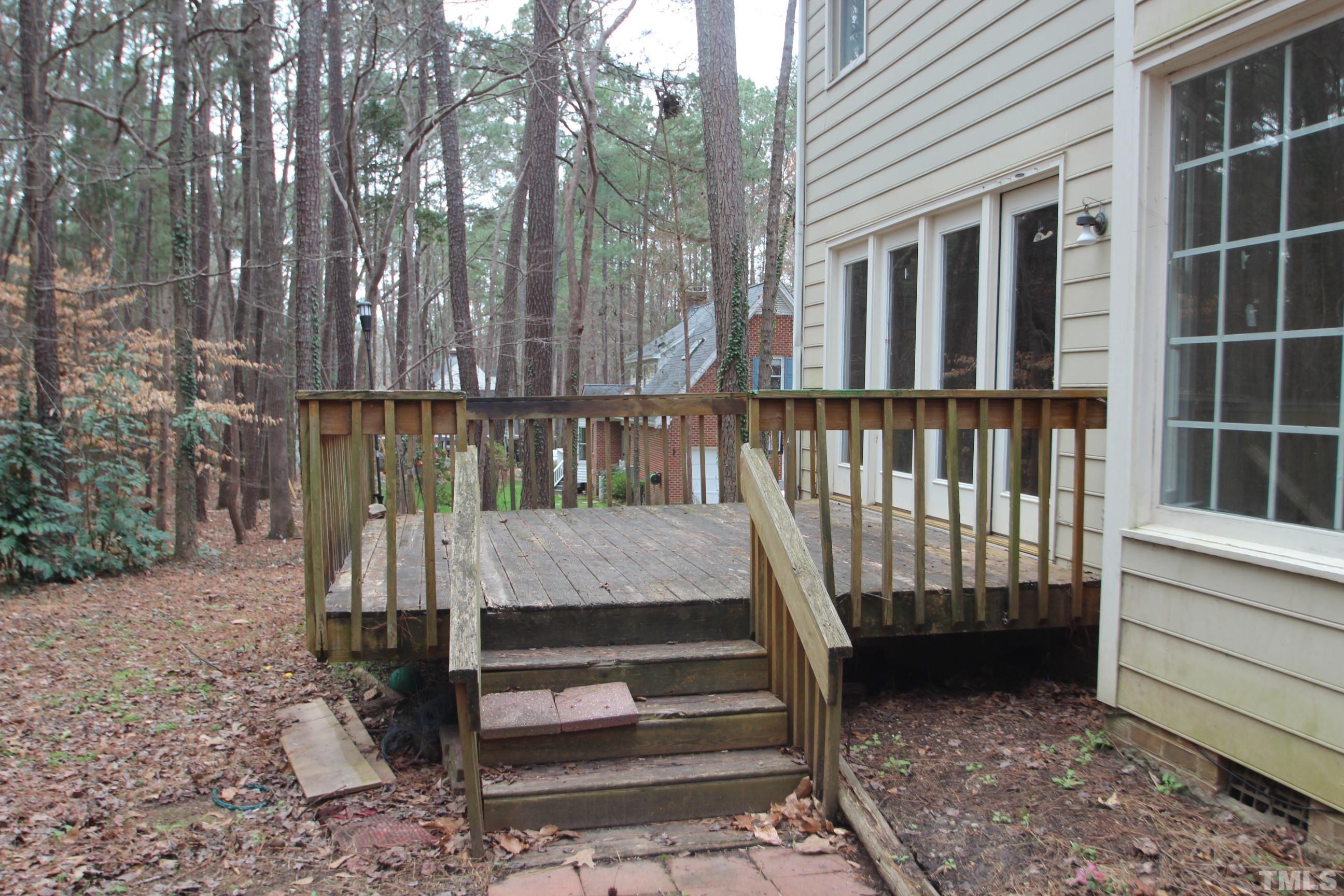 4013 Country Village Drive Raleigh, NC 27606 - Photo 4 of 23 a view of a deck with a bench next to a yard