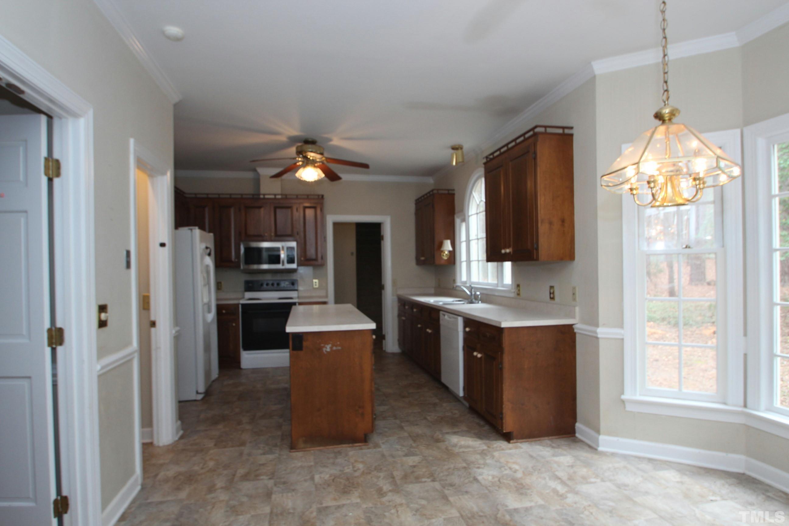 4013 Country Village Drive Raleigh, NC 27606 - Photo 6 of 23 a kitchen with cabinets and refrigerator