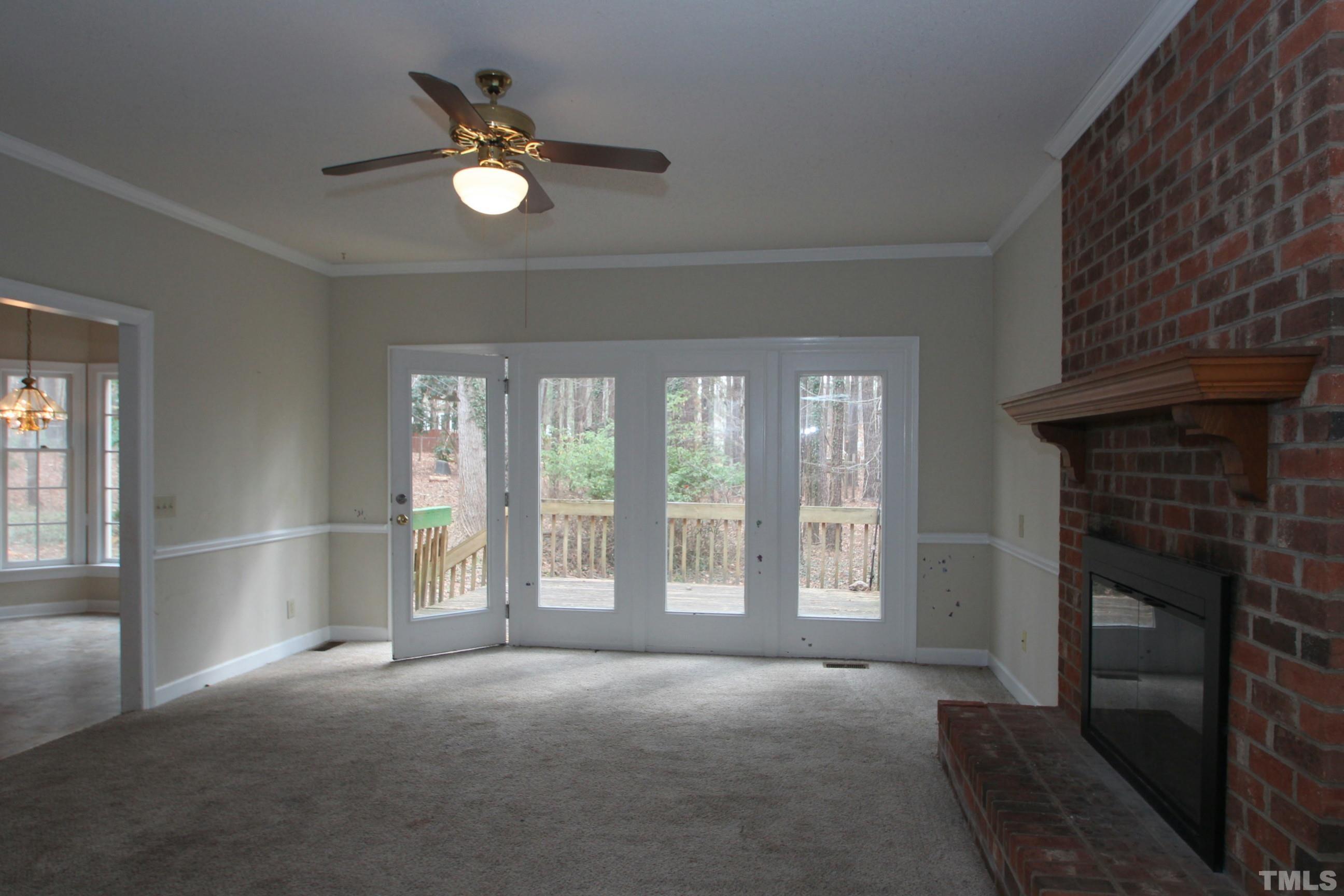 4013 Country Village Drive Raleigh, NC 27606 - Photo 9 of 23 a view of an empty room with a fireplace and a window