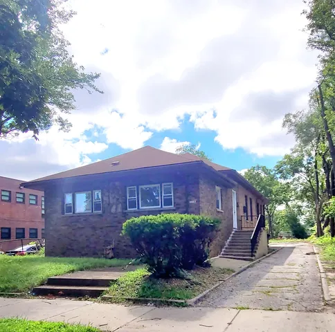 a view of a blue sign in front of a house
